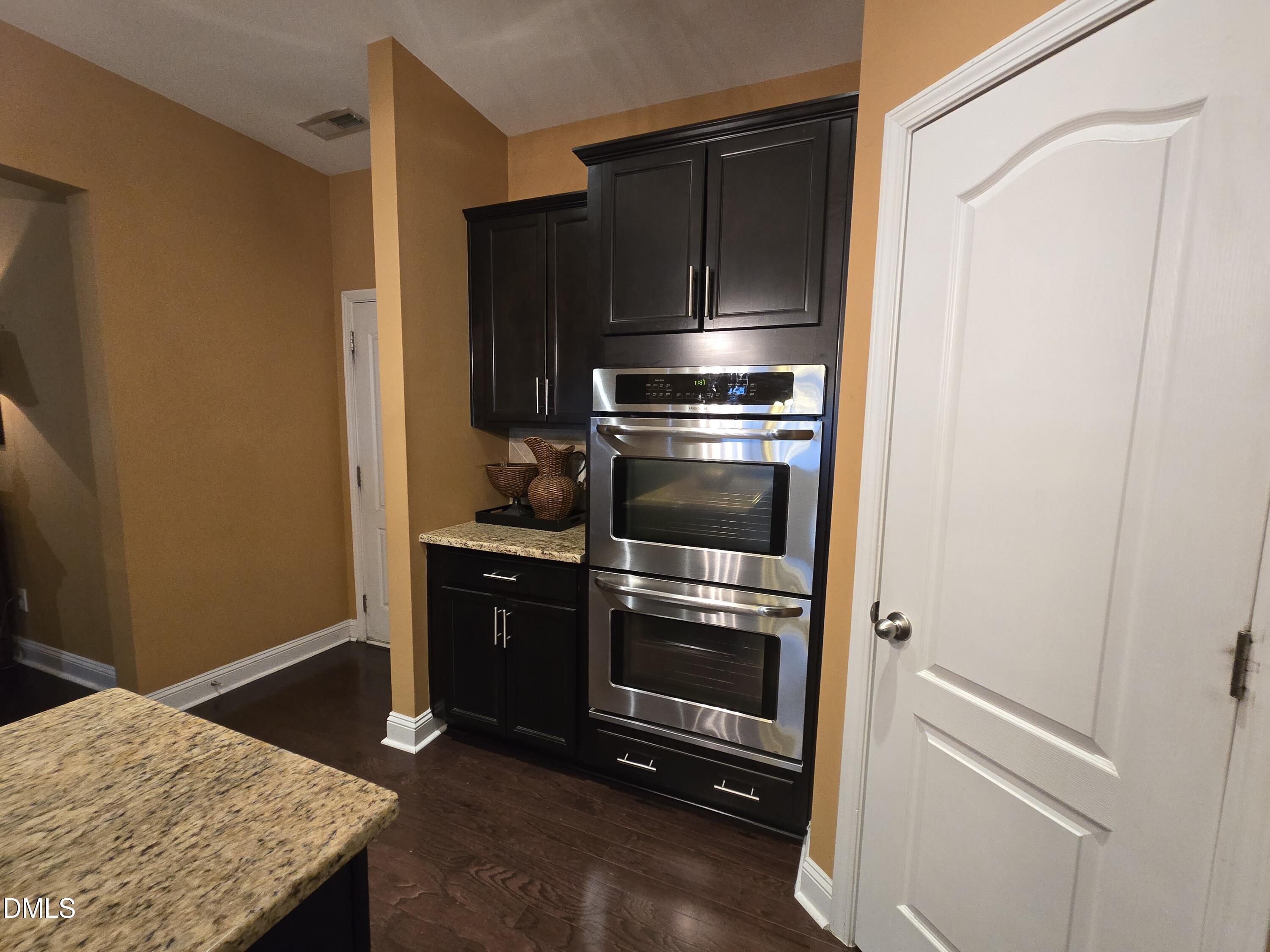 4202 Smithson Court Raleigh, NC 27616 - Photo 17 of 54 a kitchen with a refrigerator and cabinets