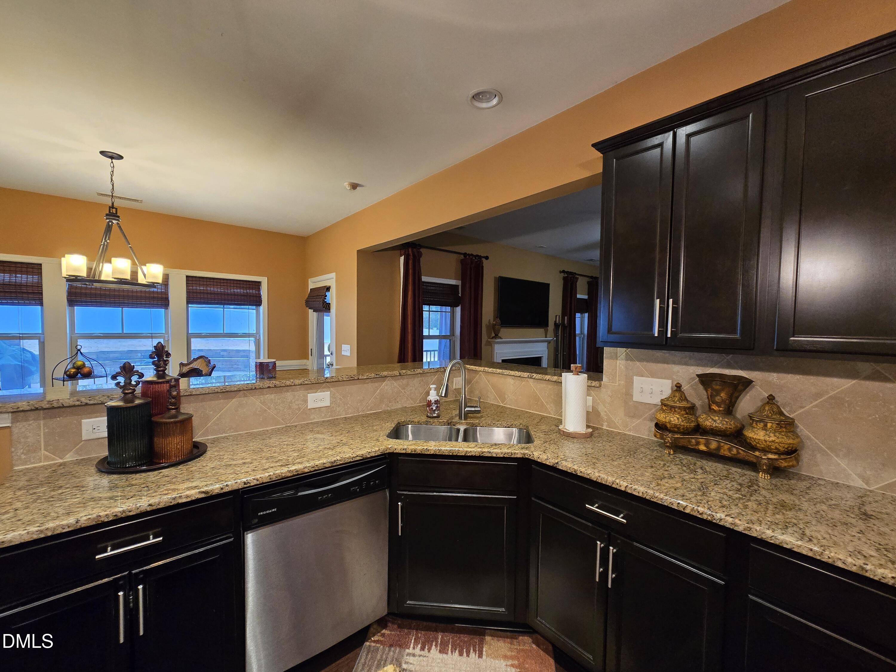 4202 Smithson Court Raleigh, NC 27616 - Photo 18 of 54 a kitchen with granite countertop stainless steel appliances a sink stove and refrigerator