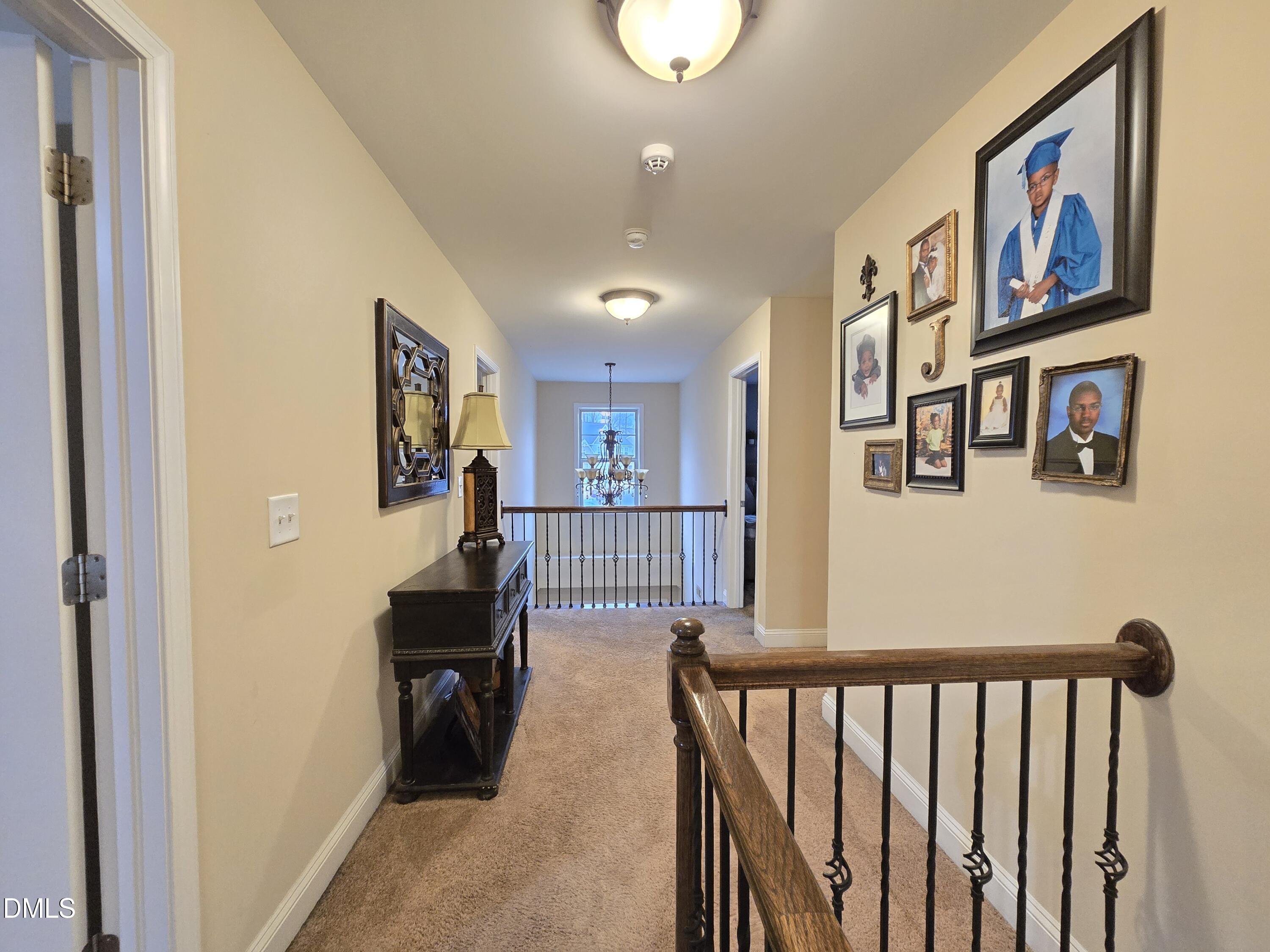 4202 Smithson Court Raleigh, NC 27616 - Photo 24 of 54 a view of a hallway with wooden floor and furniture