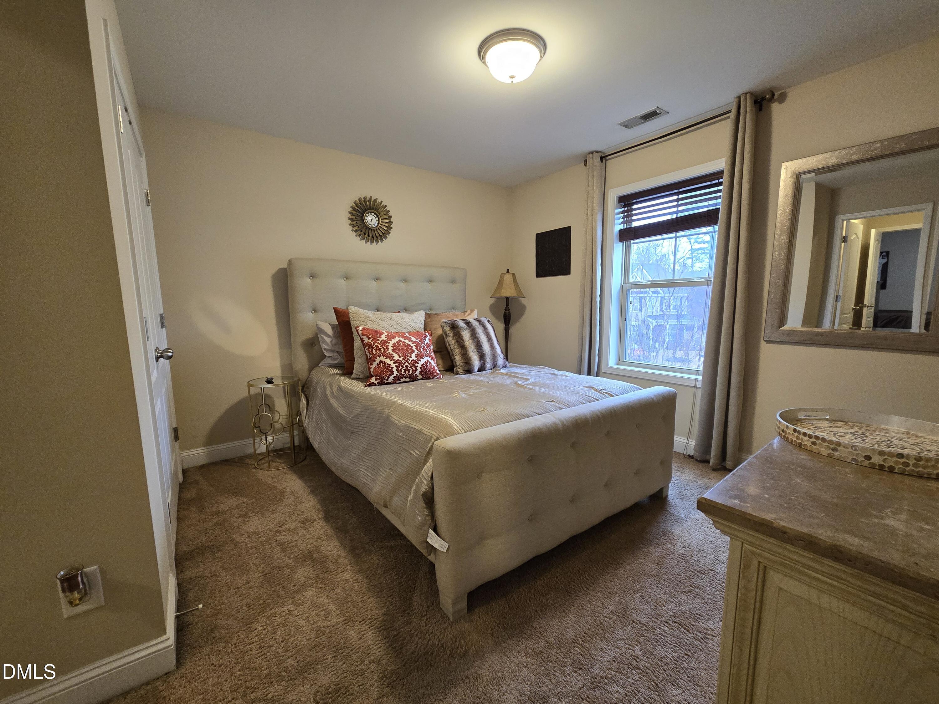 4202 Smithson Court Raleigh, NC 27616 - Photo 28 of 54 a bedroom with a bed and a table