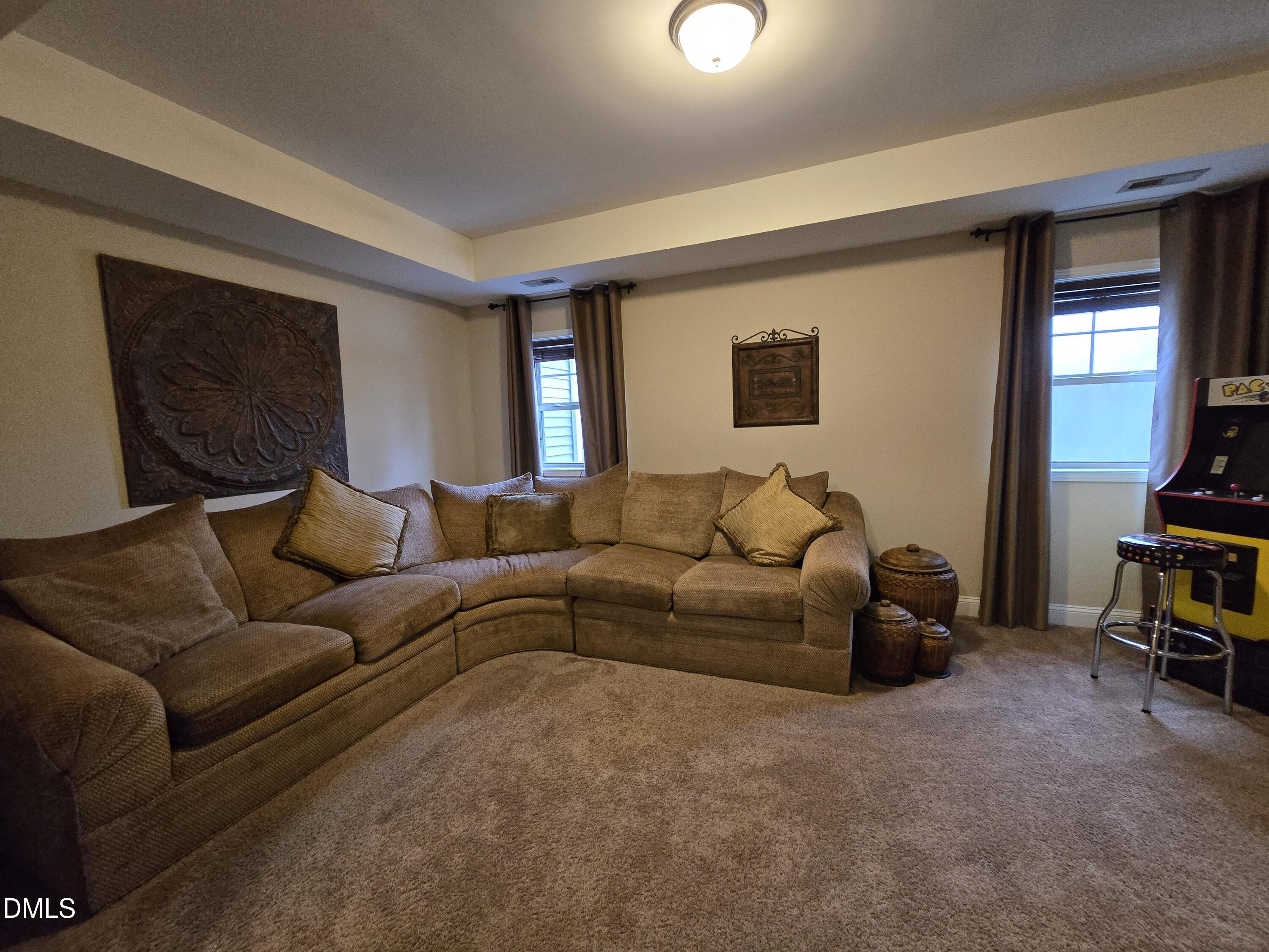 4202 Smithson Court Raleigh, NC 27616 - Photo 31 of 54 a living room with furniture and a flat screen tv