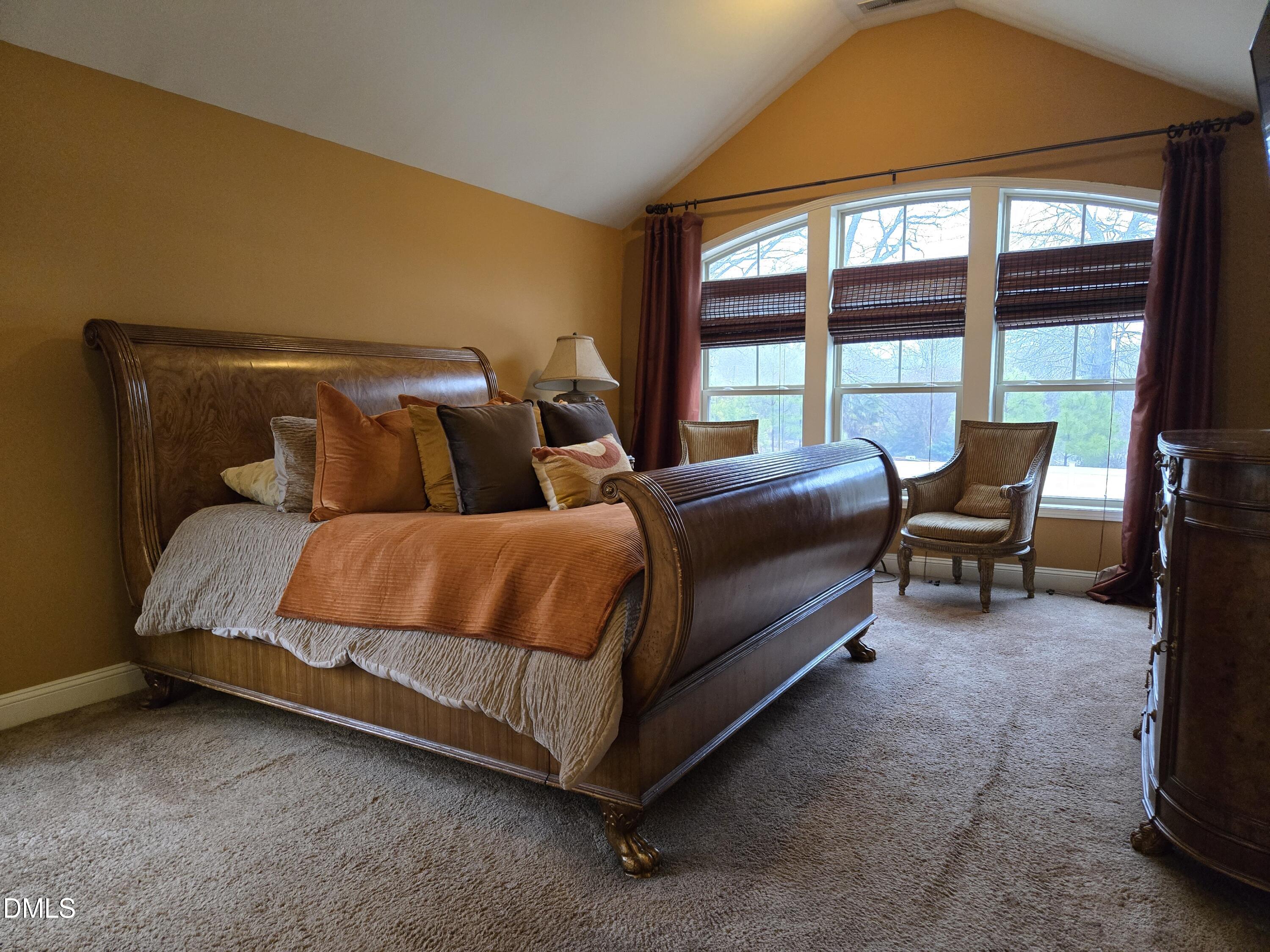 4202 Smithson Court Raleigh, NC 27616 - Photo 35 of 54 a spacious bedroom with a bed and chair