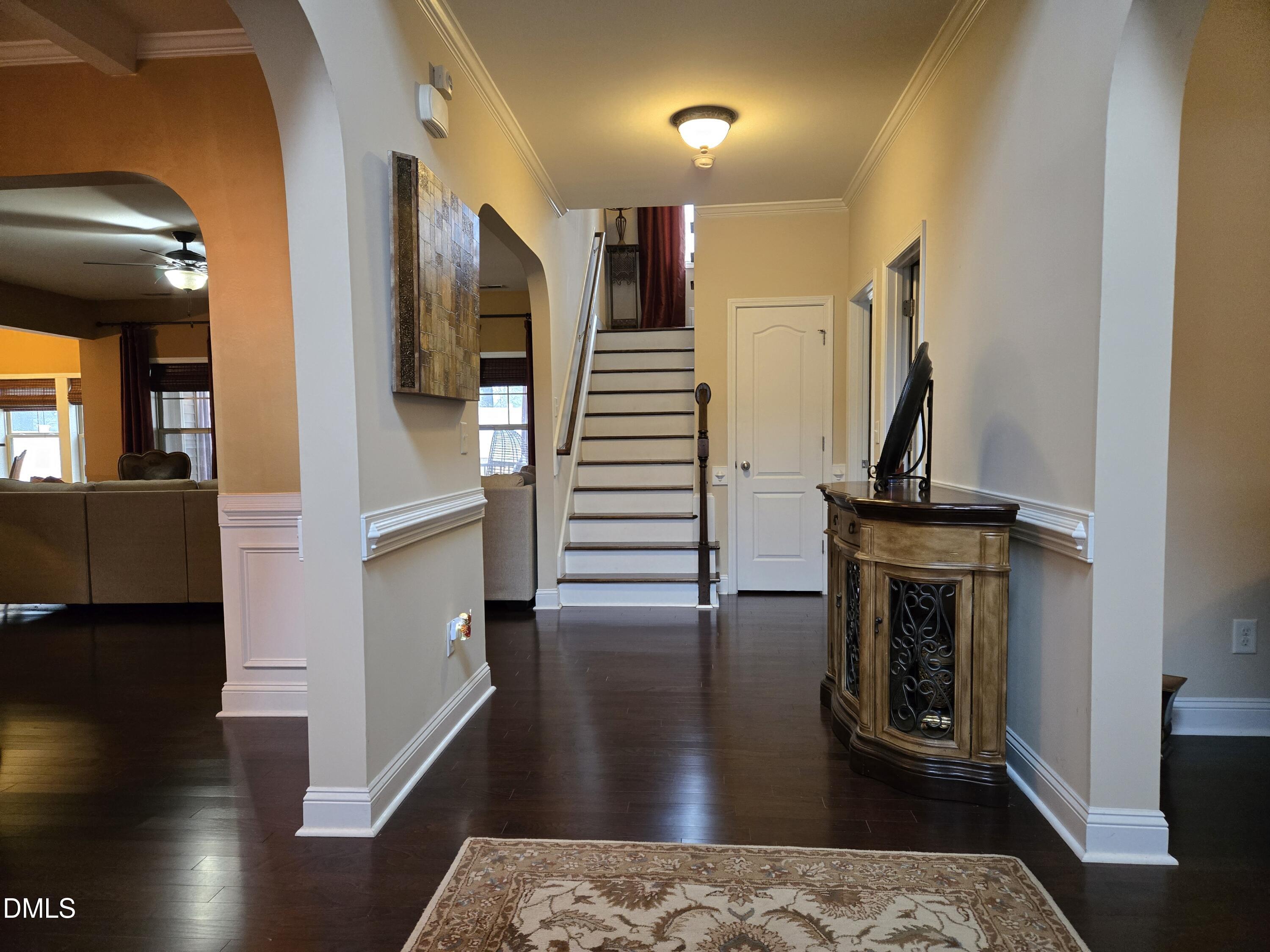 4202 Smithson Court Raleigh, NC 27616 - Photo 4 of 54 a view of a hallway view with wooden floor and staircase