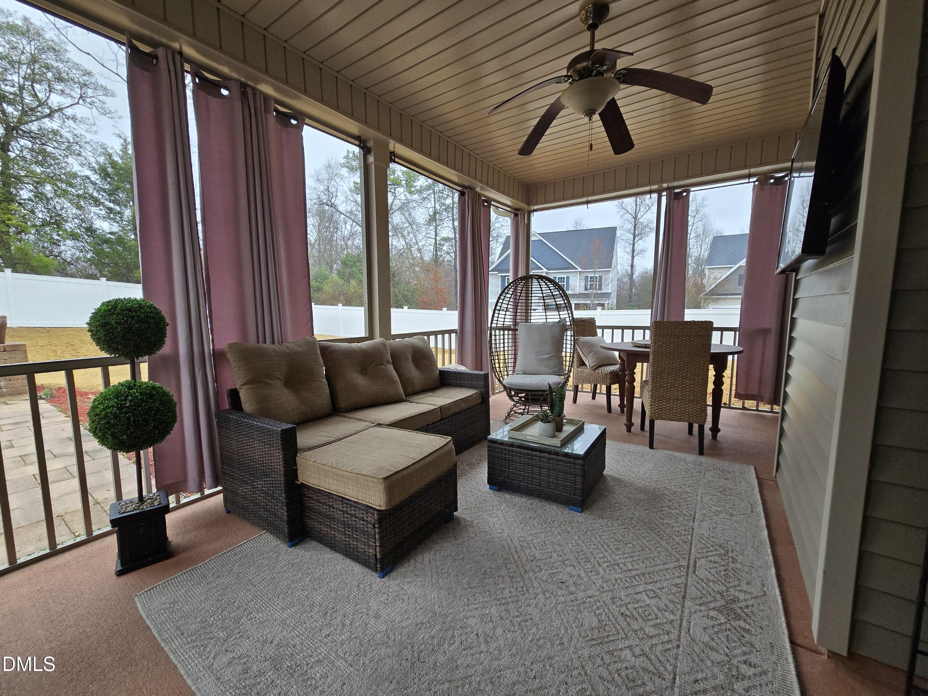 4202 Smithson Court Raleigh, NC 27616 - Photo 42 of 54 a living room with furniture and a floor to ceiling window