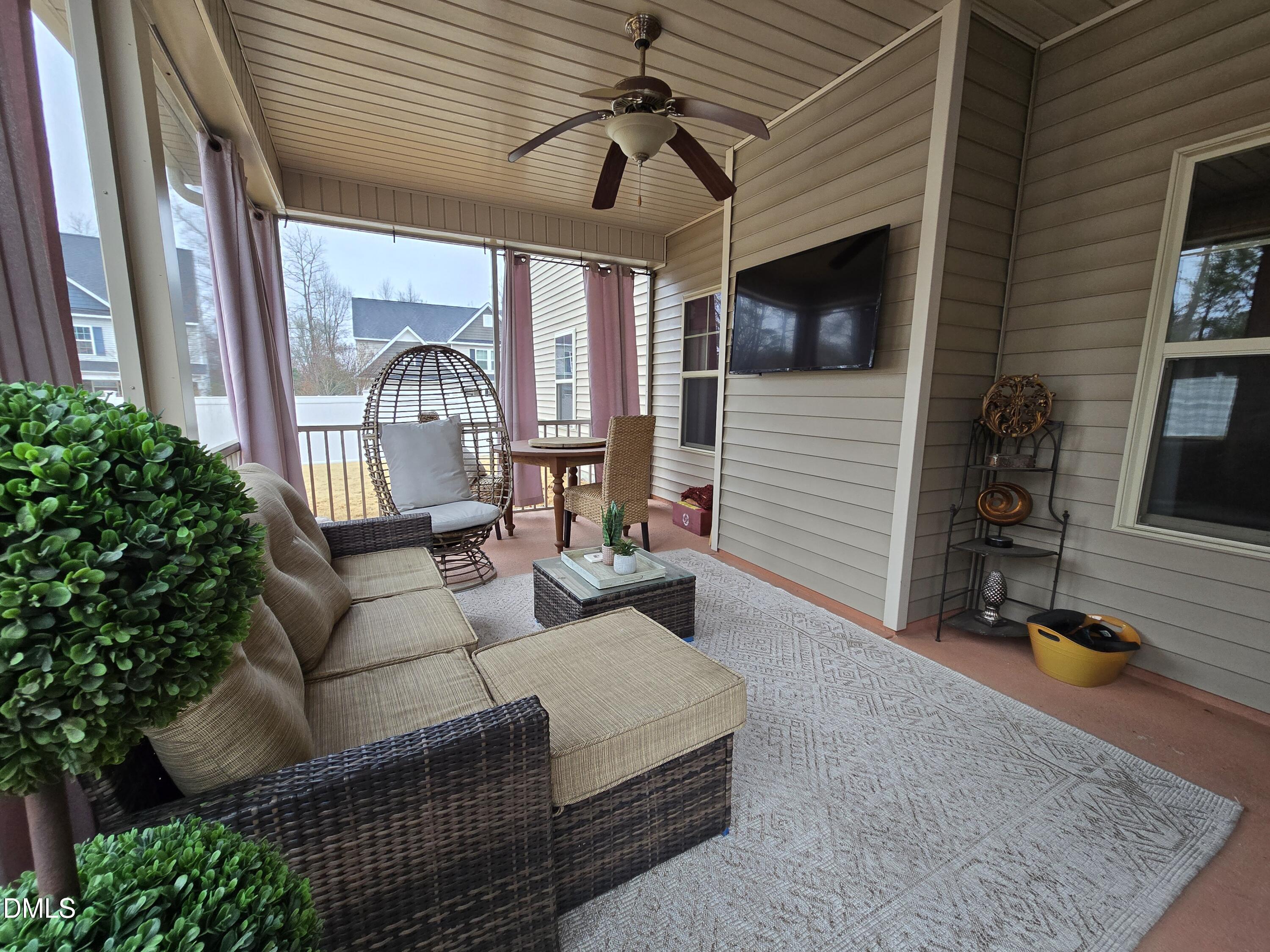 4202 Smithson Court Raleigh, NC 27616 - Photo 44 of 54 a living room with furniture a flat screen tv and a window