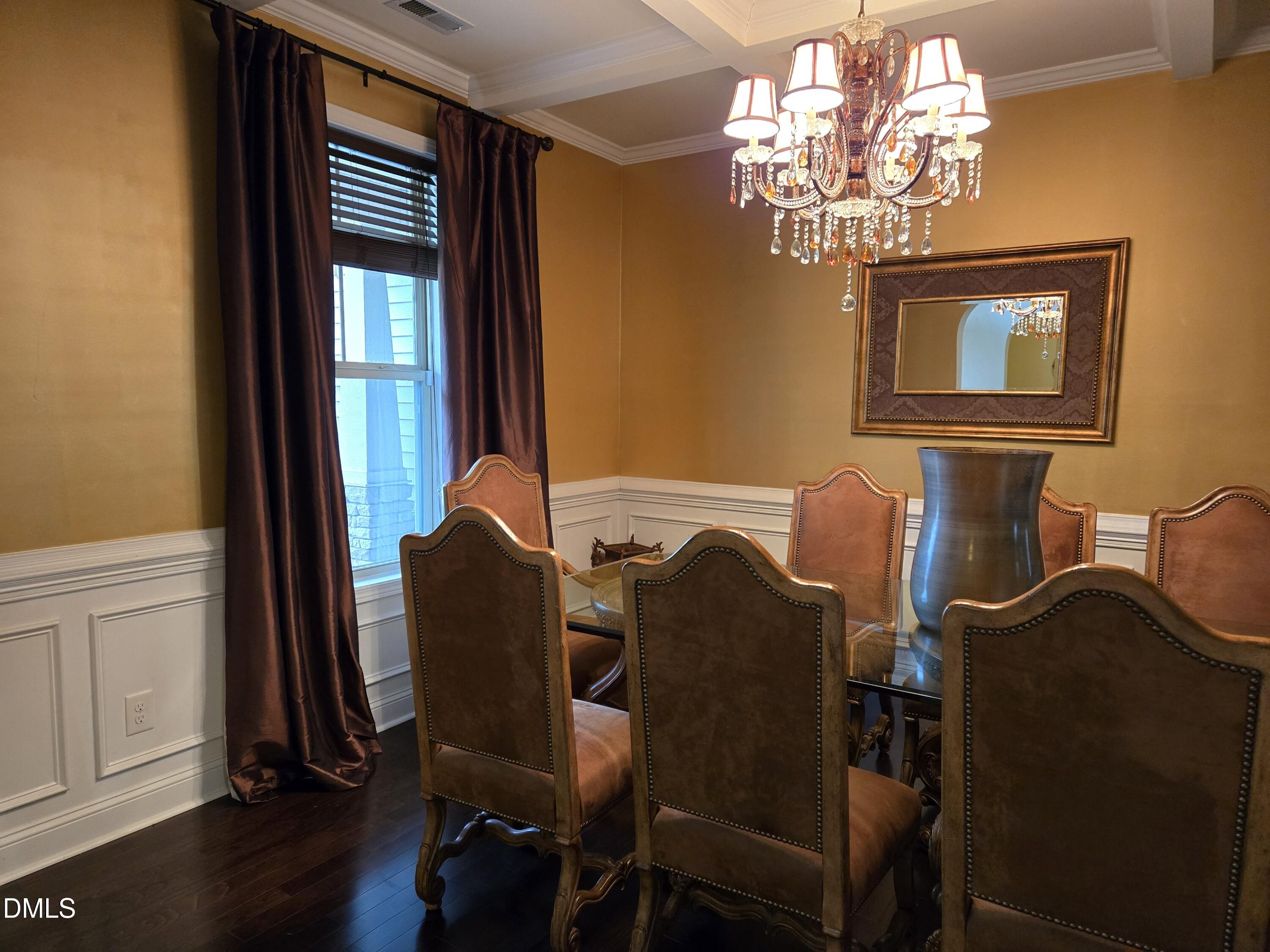 4202 Smithson Court Raleigh, NC 27616 - Photo 6 of 54 a dining room with furniture and chandelier