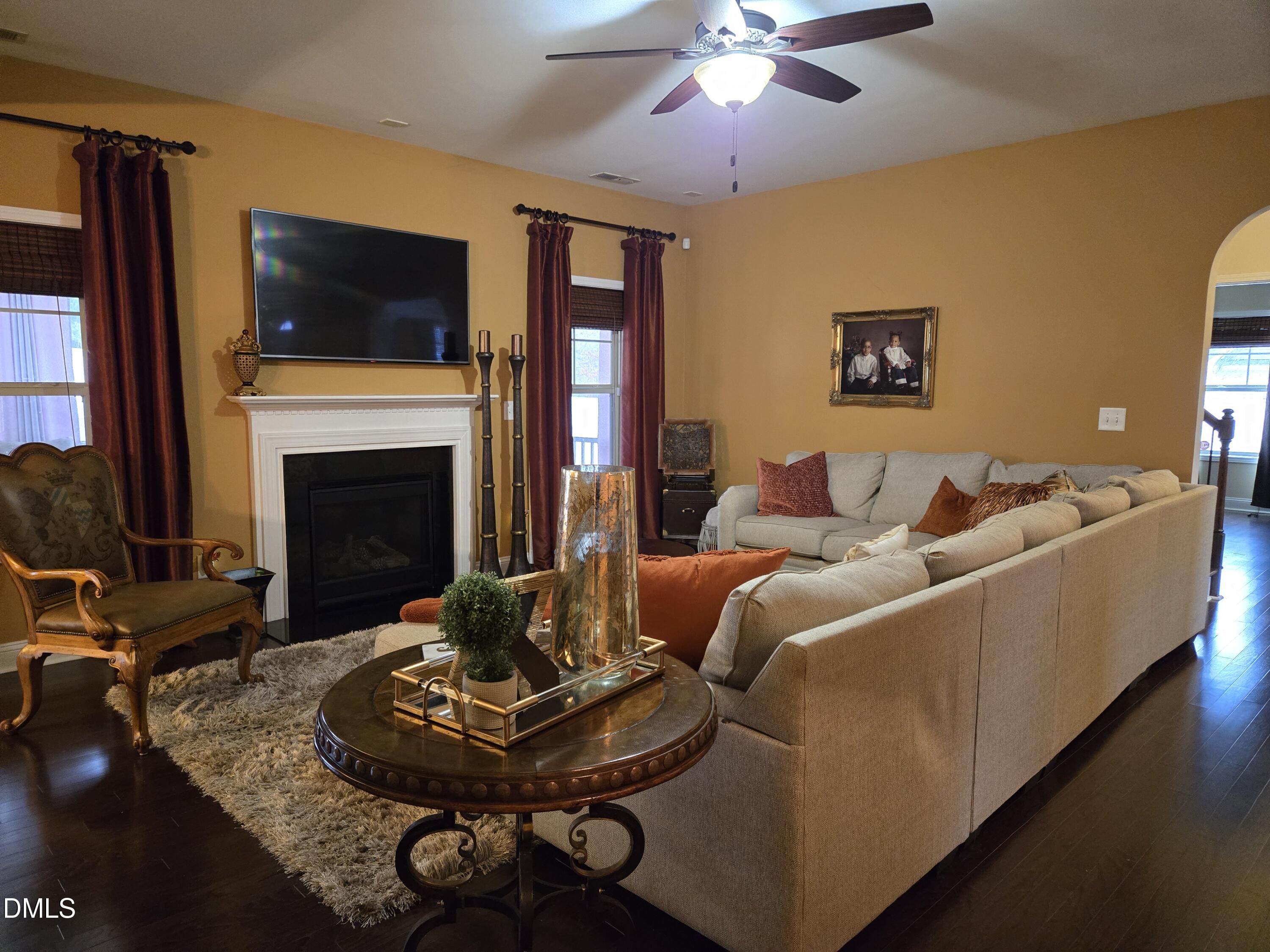 4202 Smithson Court Raleigh, NC 27616 - Photo 8 of 54 a living room with furniture a fireplace and a flat screen tv