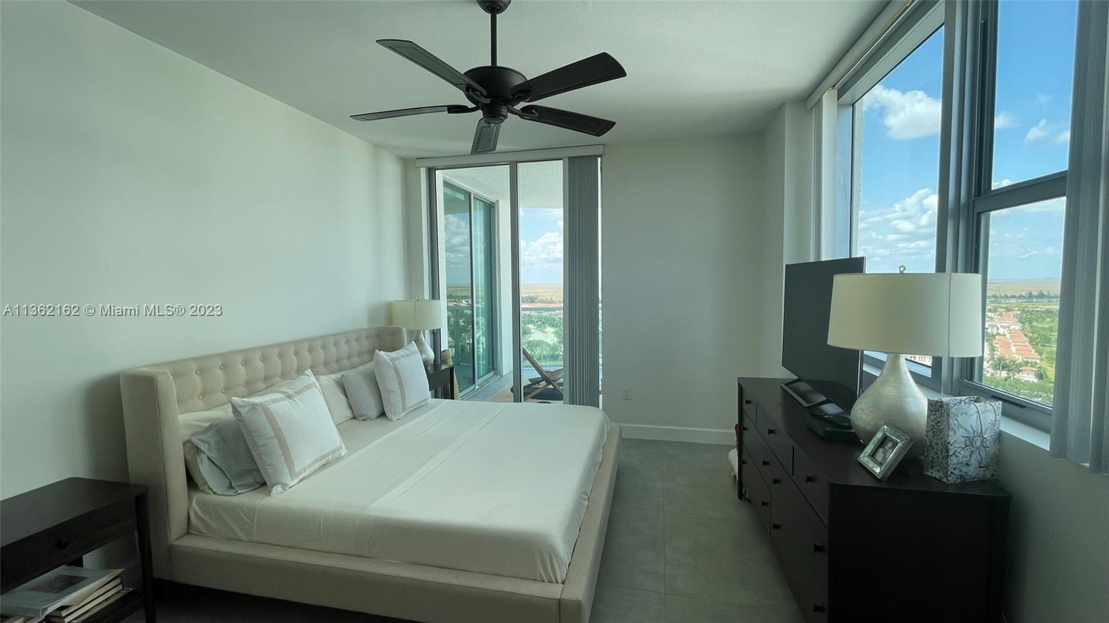 2681 North Flamingo Road, Unit 2408S Sunrise, FL 33323 - Photo 15 of 57 a living room with furniture and a flat screen tv