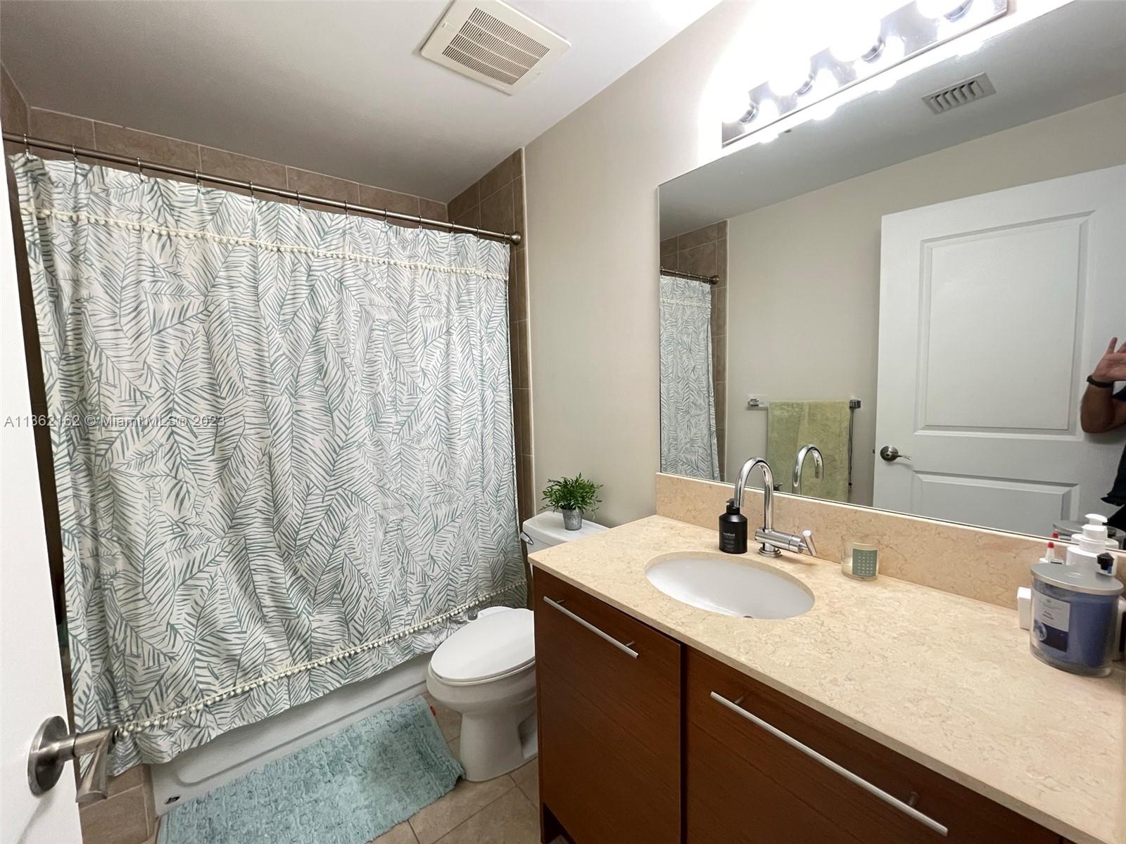 2681 North Flamingo Road, Unit 2408S Sunrise, FL 33323 - Photo 23 of 57 a bathroom with a granite countertop sink and a mirror