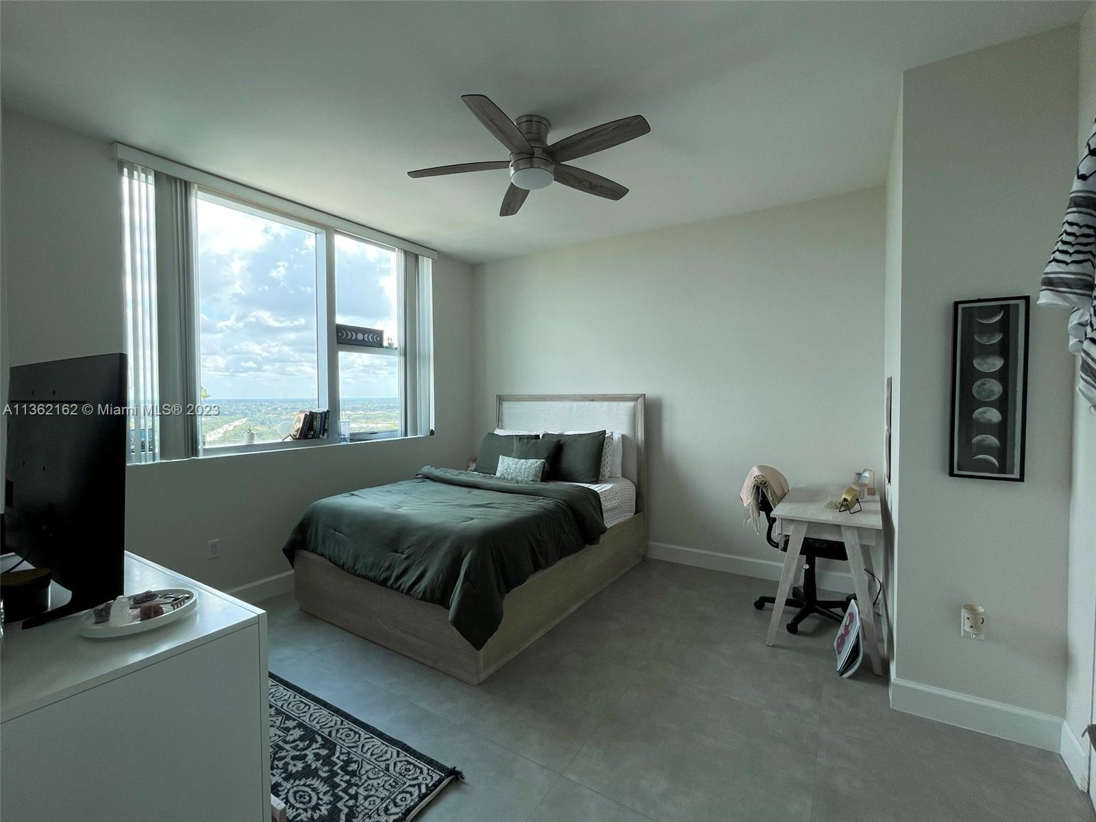 2681 North Flamingo Road, Unit 2408S Sunrise, FL 33323 - Photo 25 of 57 a bedroom with a bed and a window