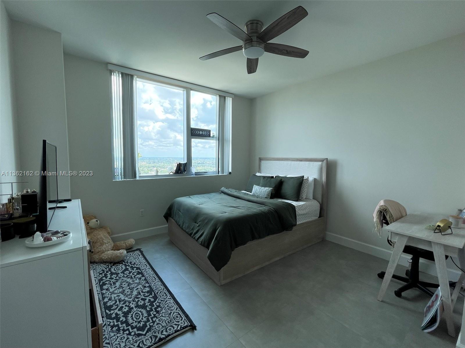 2681 North Flamingo Road, Unit 2408S Sunrise, FL 33323 - Photo 27 of 57 a bedroom with a bed and a window