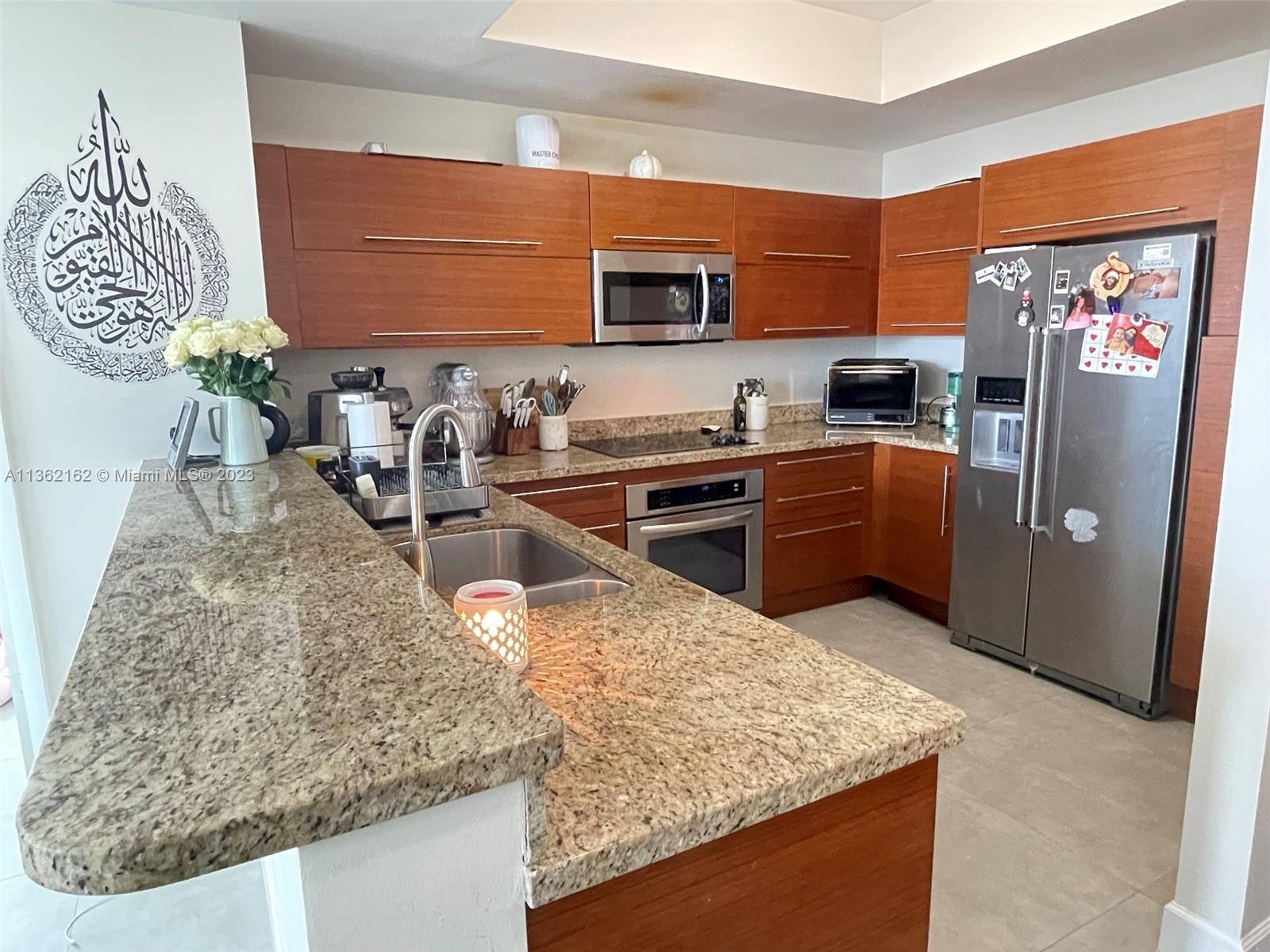 2681 North Flamingo Road, Unit 2408S Sunrise, FL 33323 - Photo 3 of 57 a kitchen with stainless steel appliances granite countertop a sink stove and refrigerator