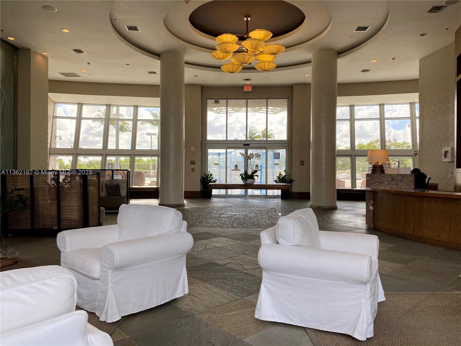 2681 North Flamingo Road, Unit 2408S Sunrise, FL 33323 - Photo 34 of 57 a living room with furniture and a large window