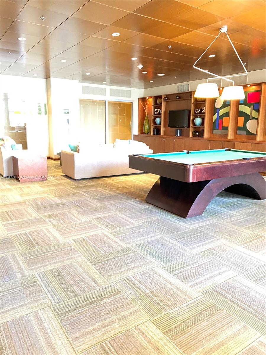 2681 North Flamingo Road, Unit 2408S Sunrise, FL 33323 - Photo 35 of 57 a swimming pool with outdoor seating