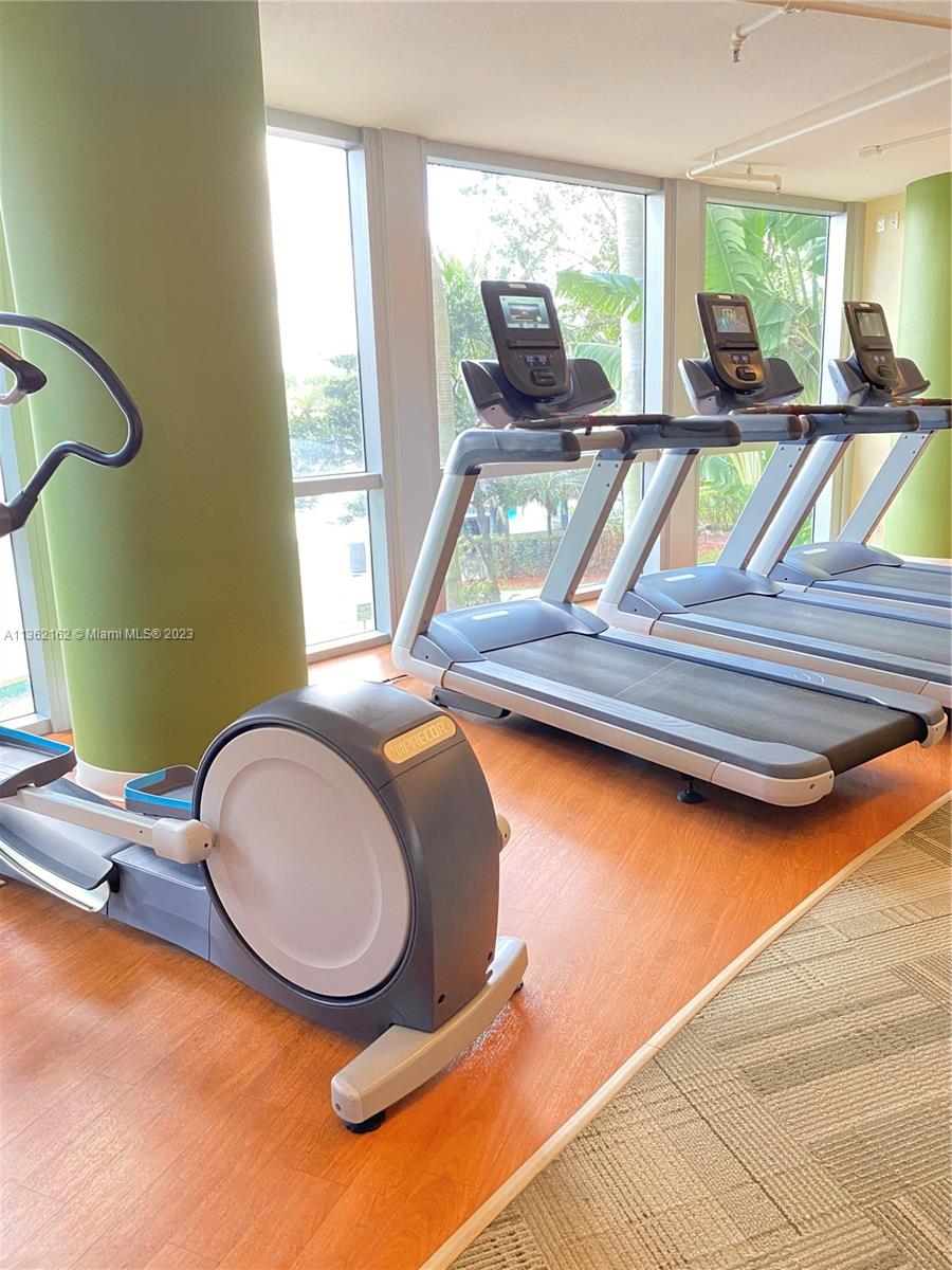 2681 North Flamingo Road, Unit 2408S Sunrise, FL 33323 - Photo 40 of 57 a room with gym equipment and a large window