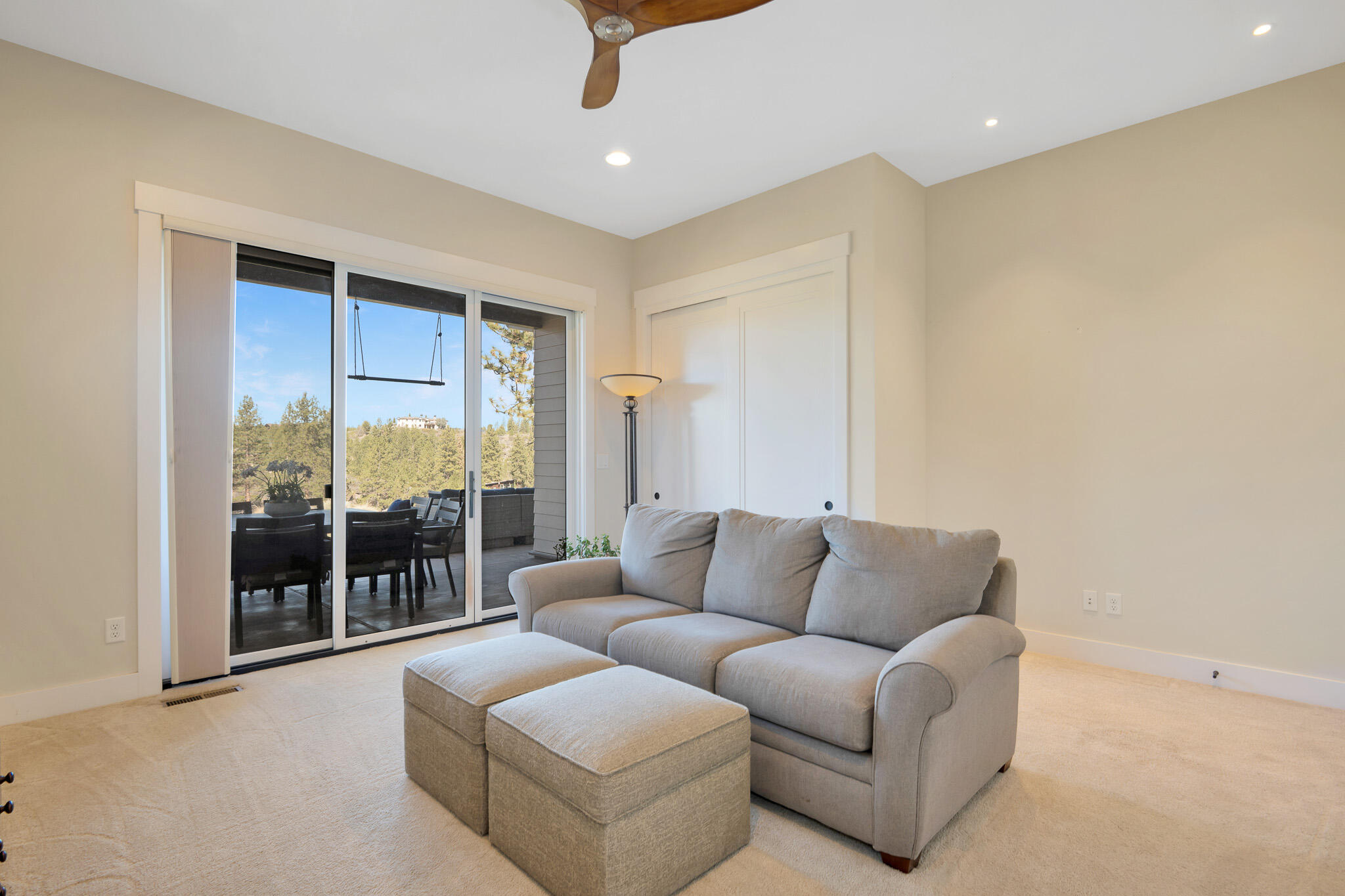60871 River Rim Drive Bend, OR 97702 - Photo 35 of 42 a living room with furniture and a floor to ceiling window