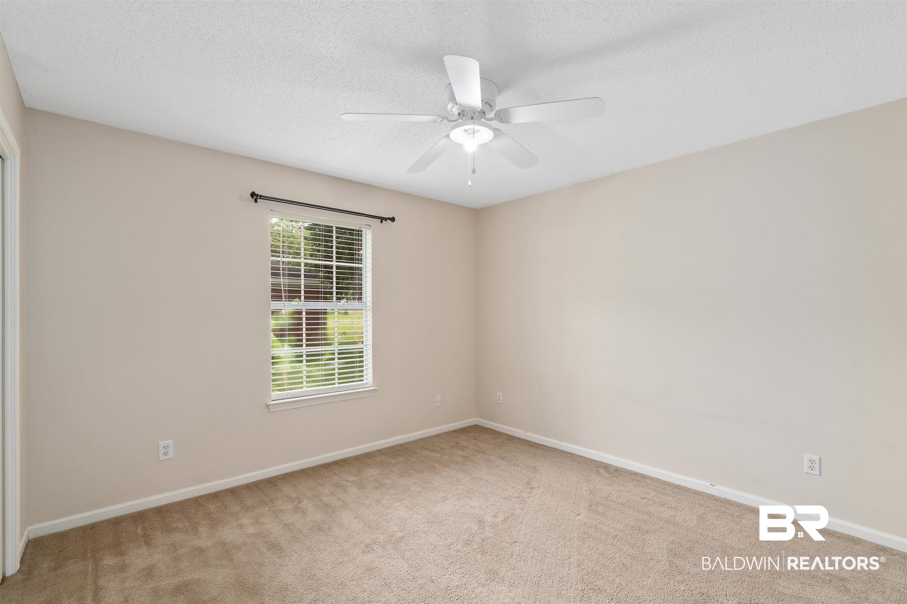 25779 Austin Road Daphne, AL 36526 - Photo 13 of 30 Empty room with carpet flooring, baseboards, ceiling fan, and a textured ceiling