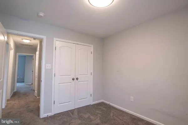 an empty room with closet area
