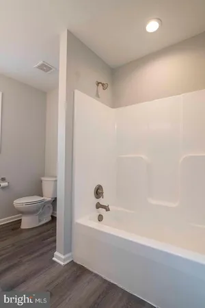 a bathroom with a bathtub and a toilet