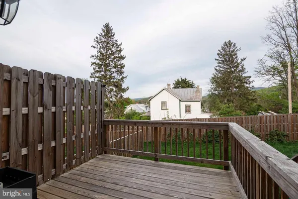 a view of wooden deck and a yard