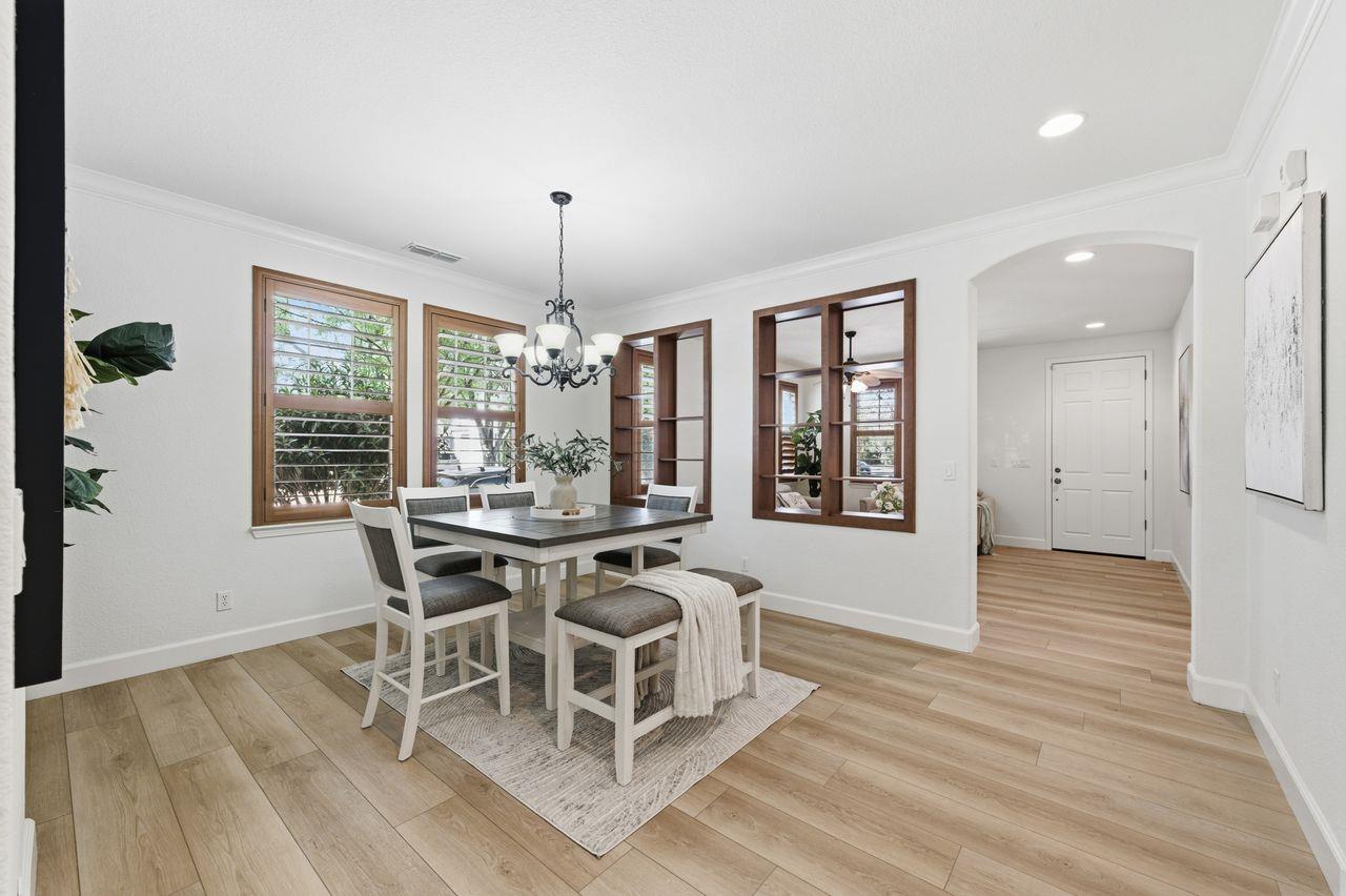 698 West Rico Way Tracy, CA 95391 - Photo 7 of 38 a view of a dining room with furniture window and wooden floor
