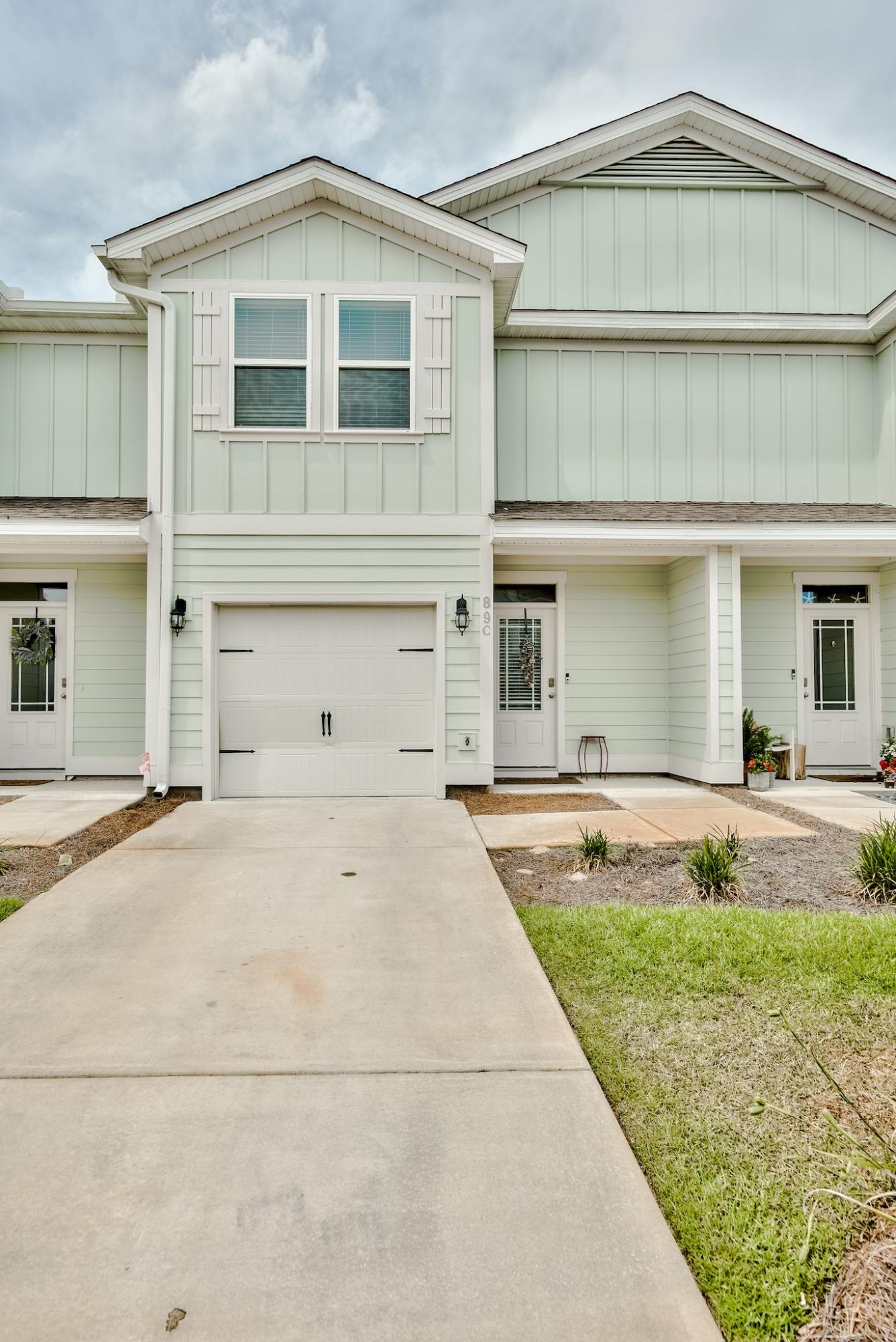 89 Crossing Lane, Unit C Santa Rosa Beach, FL 32459 - Photo 2 of 27 a front view of a house with garden