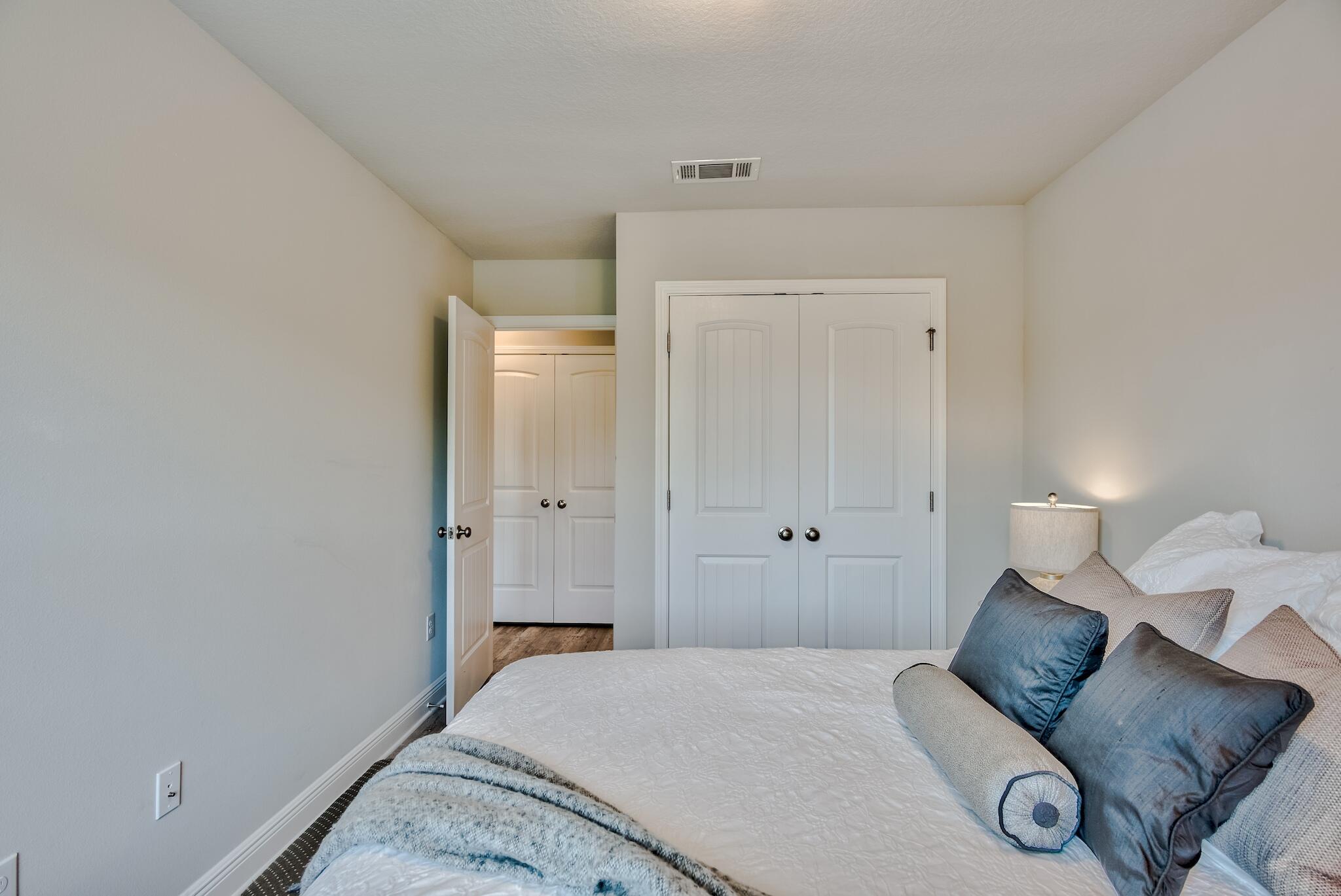 89 Crossing Lane, Unit C Santa Rosa Beach, FL 32459 - Photo 19 of 27 a bedroom with a bed and lamp