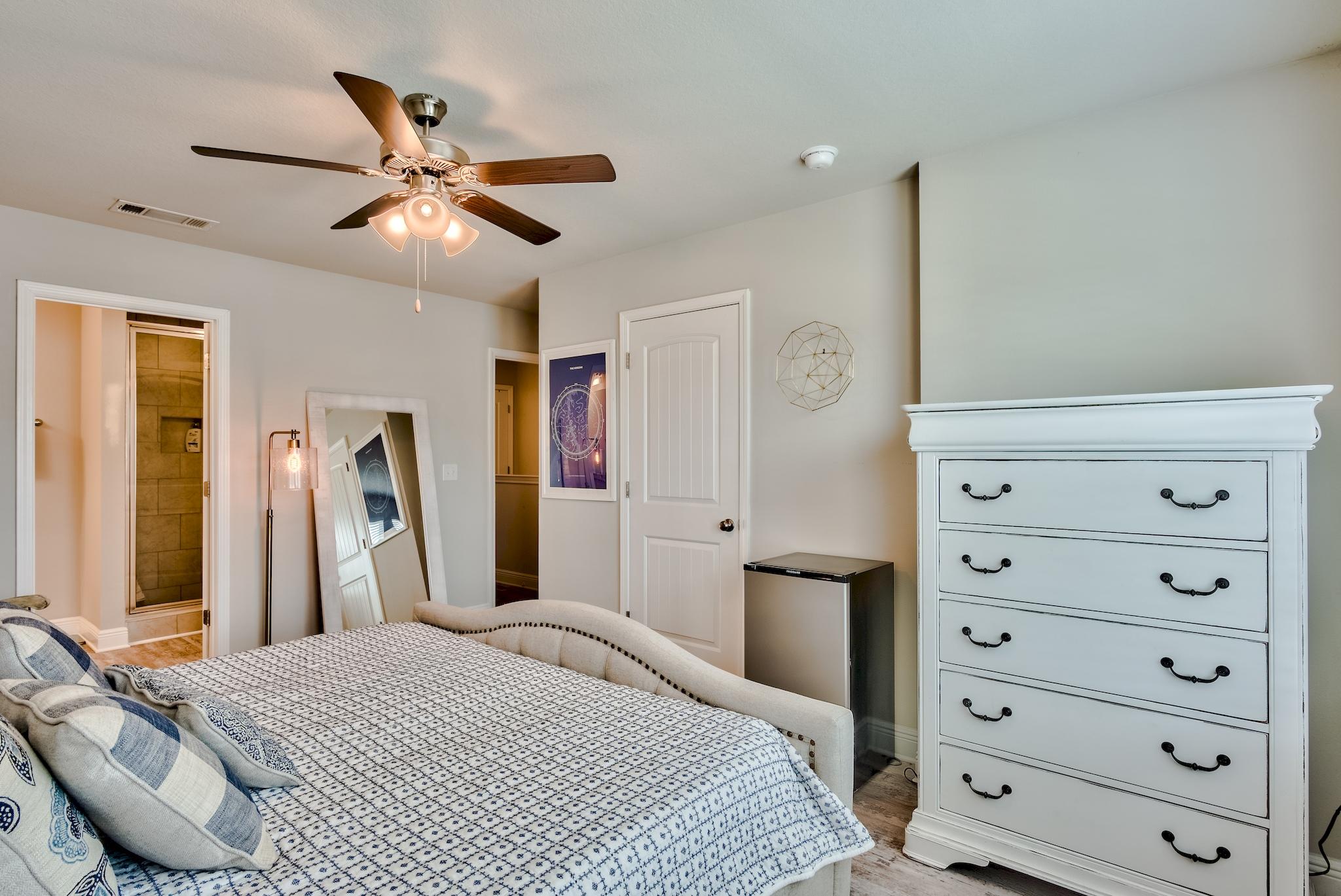 89 Crossing Lane, Unit C Santa Rosa Beach, FL 32459 - Photo 22 of 27 a bedroom with a bed and a chandelier
