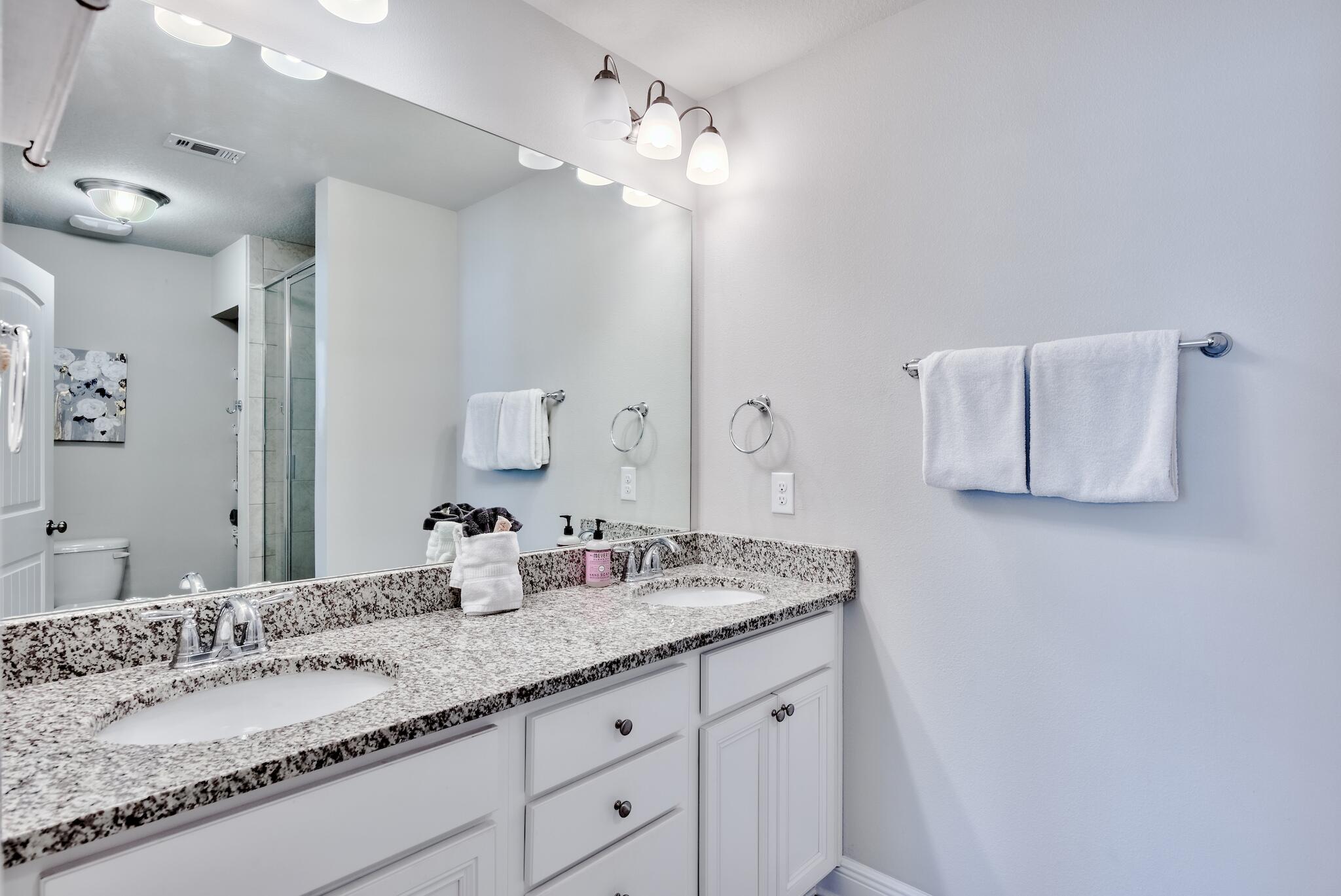89 Crossing Lane, Unit C Santa Rosa Beach, FL 32459 - Photo 23 of 27 a bathroom with a granite countertop sink and a mirror