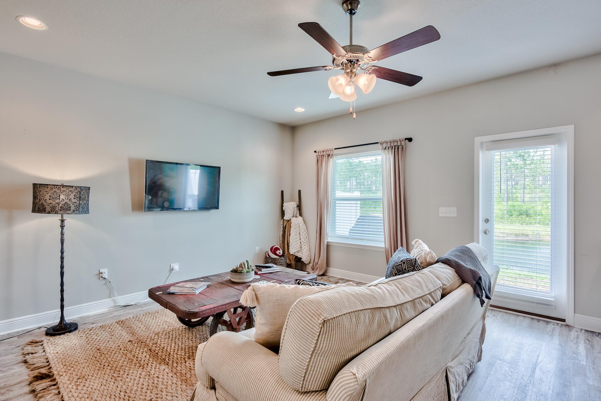 89 Crossing Lane, Unit C Santa Rosa Beach, FL 32459 - Photo 6 of 27 a bedroom with a bed and a chandelier