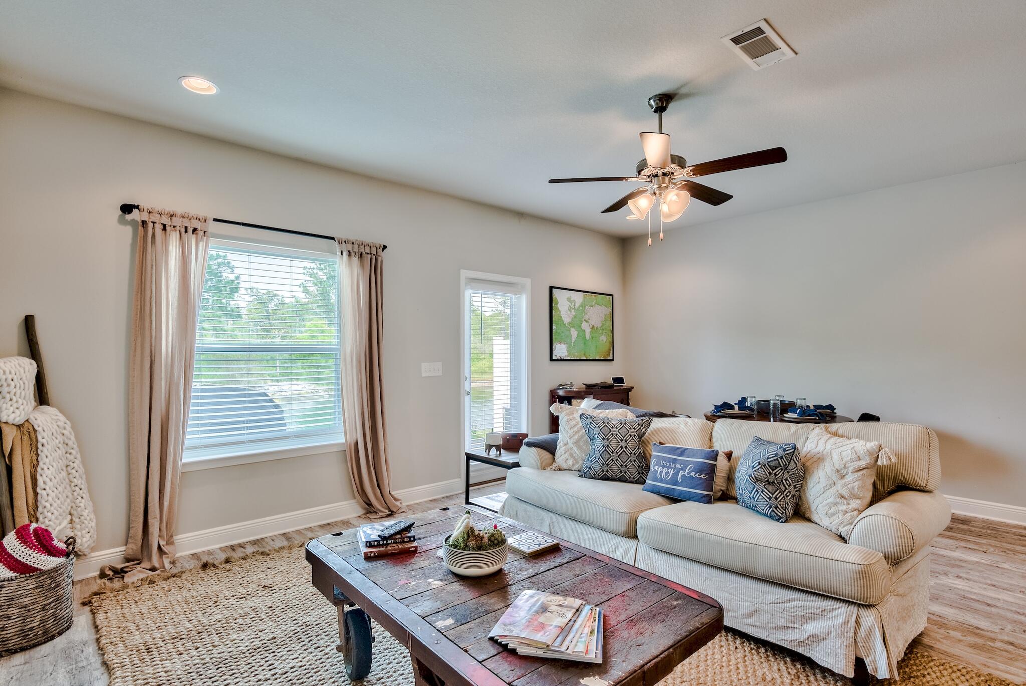 89 Crossing Lane, Unit C Santa Rosa Beach, FL 32459 - Photo 8 of 27 a living room with furniture a chandelier and a window