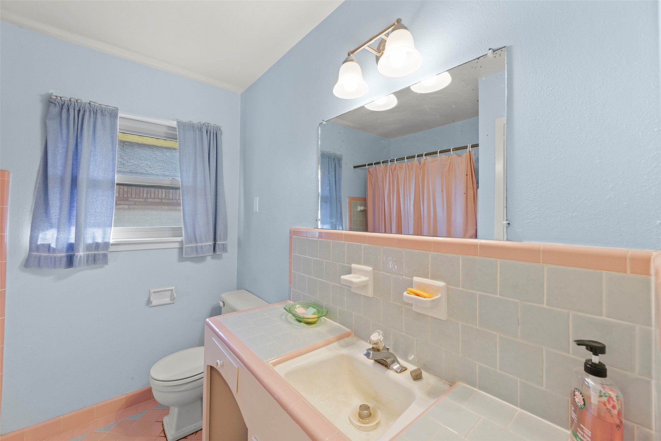 6834 Leader Street Houston, TX 77074 - Photo 9 of 20 a bathroom with a sink a toilet and mirror