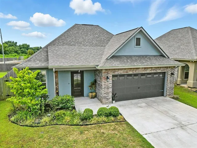 a front view of a house with a garden