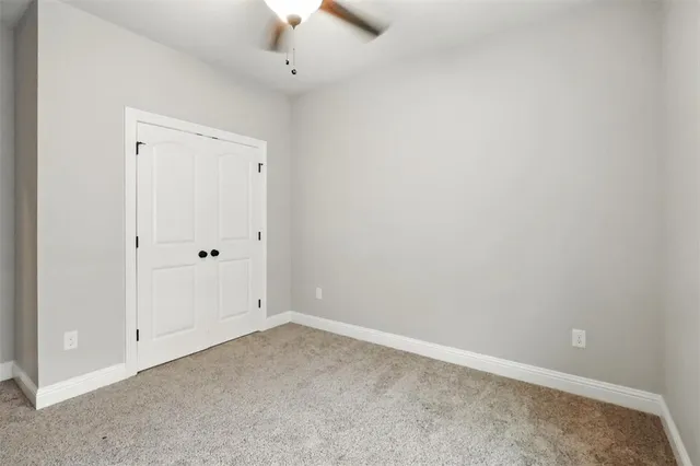 an empty room with a ceiling fan