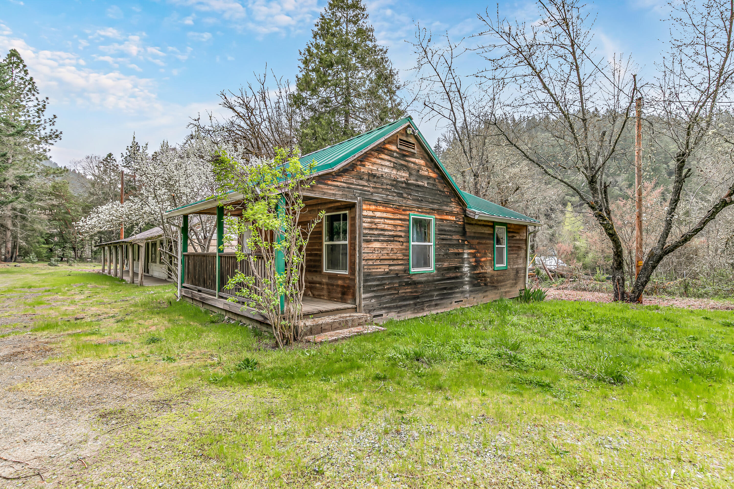 159 Bloom Road Wolf Creek, OR 97497 - Photo 6 of 38 a view of a house with a yard patio and fire pit