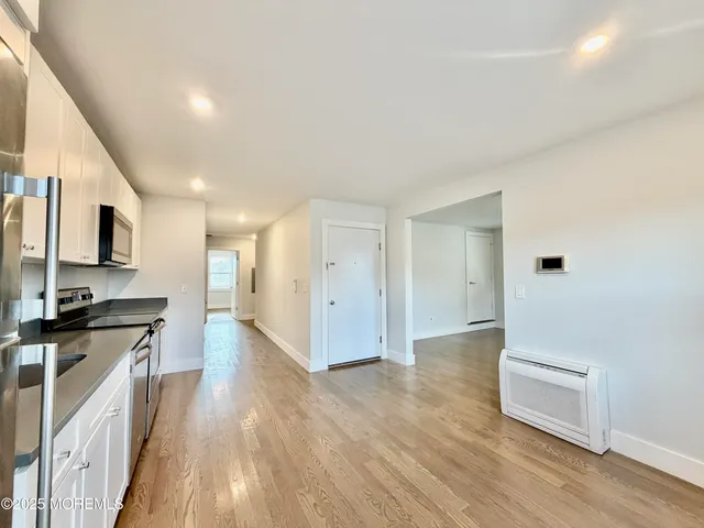 a view of a kitchen with a sink and a stove top oven