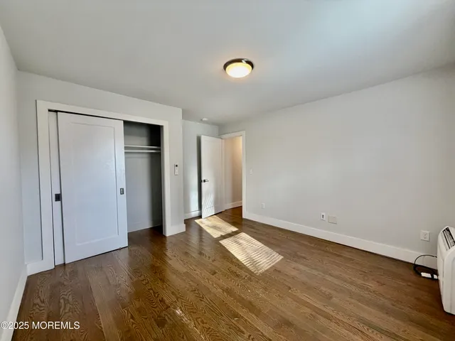 a view of an empty room and wooden floor