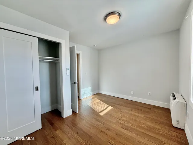 a view of a room with wooden floor and window