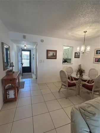 a living room with furniture and a dining table