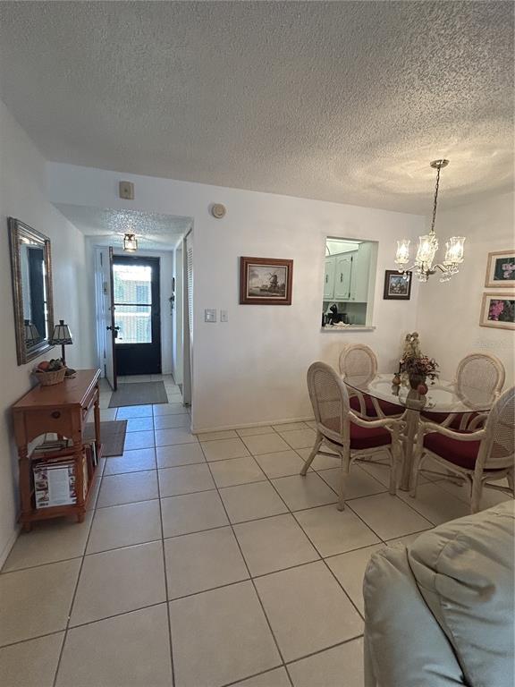11485 Oakhurst Road, Unit 200318 Largo, FL 33774 - Photo 11 of 48 a living room with furniture and a dining table