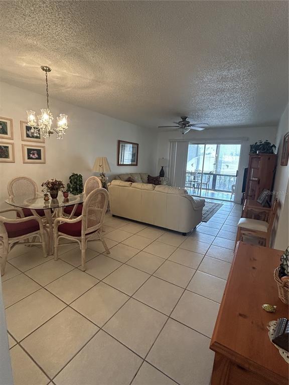 11485 Oakhurst Road, Unit 200318 Largo, FL 33774 - Photo 12 of 48 a living room with furniture and a chandelier