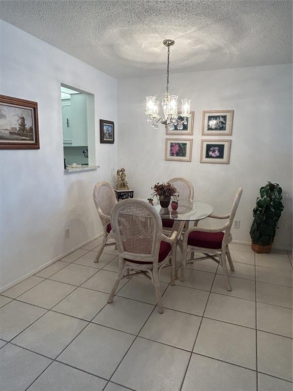 11485 Oakhurst Road, Unit 200318 Largo, FL 33774 - Photo 13 of 48 a view of a livingroom with furniture and chandelier