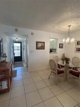 a living room with furniture a dining table and a mirror
