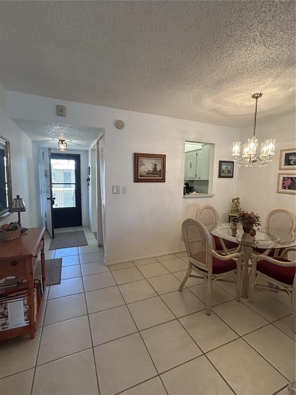 11485 Oakhurst Road, Unit 200318 Largo, FL 33774 - Photo 14 of 48 a living room with furniture a dining table and a mirror