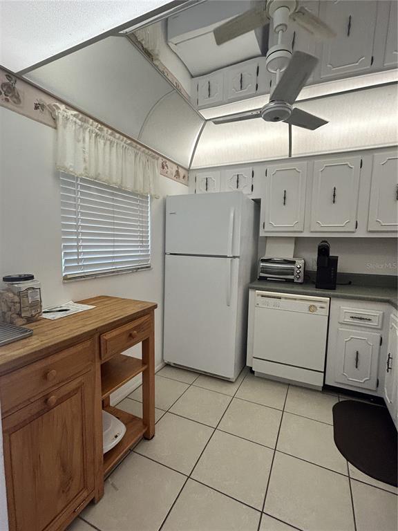 11485 Oakhurst Road, Unit 200318 Largo, FL 33774 - Photo 15 of 48 a kitchen with cabinets and white appliances