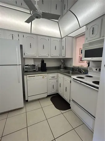 a kitchen with a sink a stove and cabinets