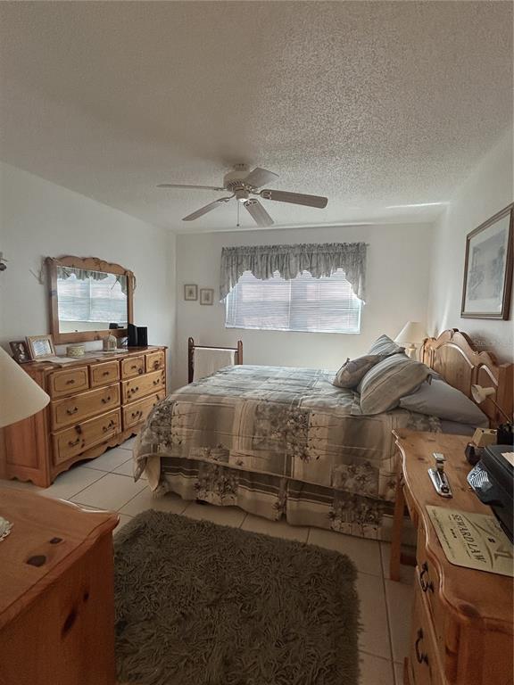 11485 Oakhurst Road, Unit 200318 Largo, FL 33774 - Photo 20 of 48 a bedroom with a bed and wooden floor