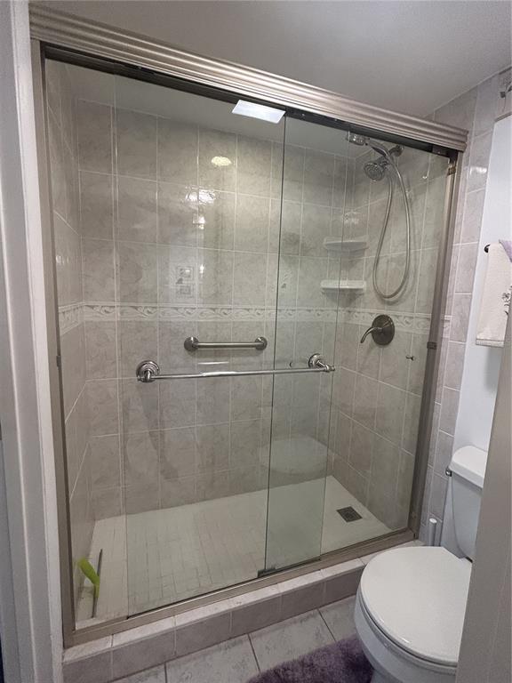 11485 Oakhurst Road, Unit 200318 Largo, FL 33774 - Photo 24 of 48 a bathroom with a shower and a toilet