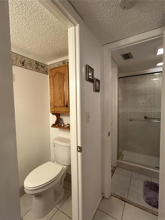 11485 Oakhurst Road, Unit 200318 Largo, FL 33774 - Photo 27 of 48 a bathroom with a toilet and a shower