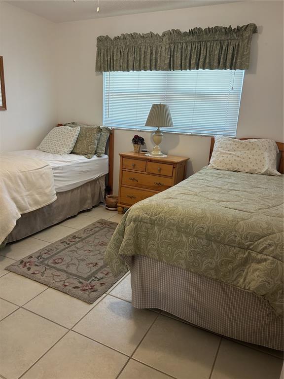 11485 Oakhurst Road, Unit 200318 Largo, FL 33774 - Photo 29 of 48 a bedroom with a bed and a couch